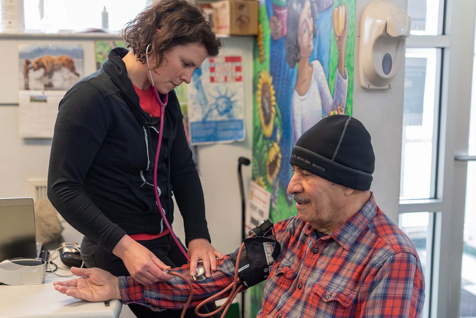 nurse taking blood pressure of patient